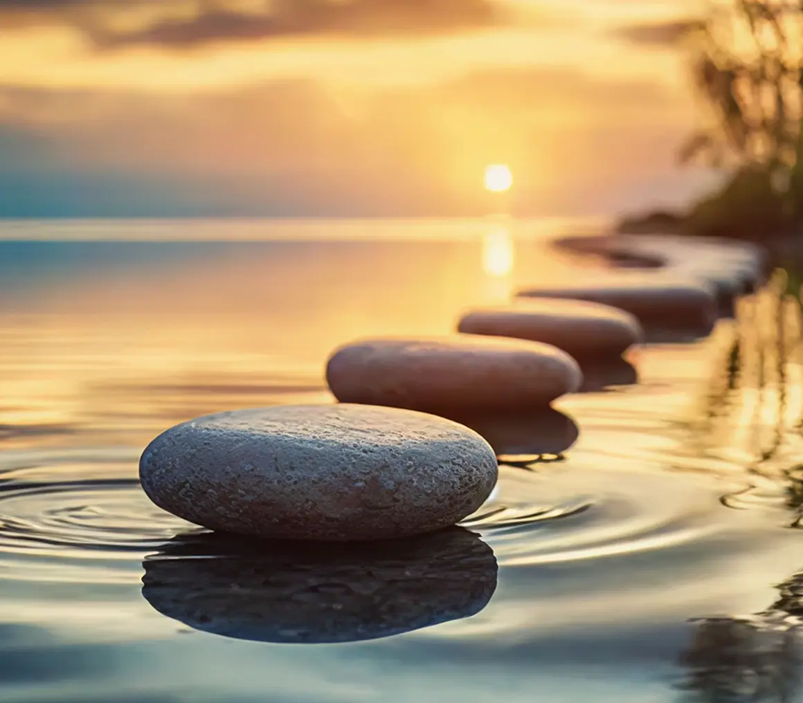 Peaceful lake with stones and sunset sky
