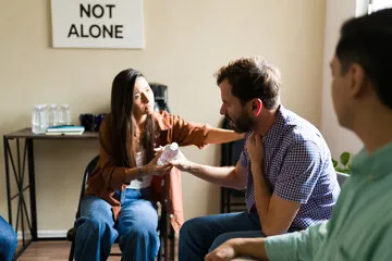Two people in a supportive conversation, one comforting the other.