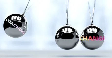 Close-up of shiny silver Christmas ornaments hanging.